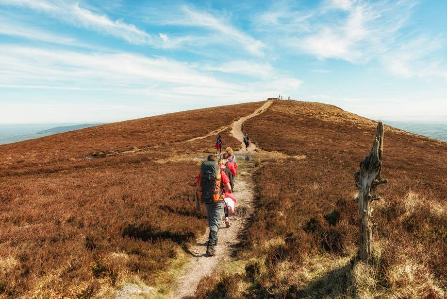 Hikers walking up a mountain in Limerick.