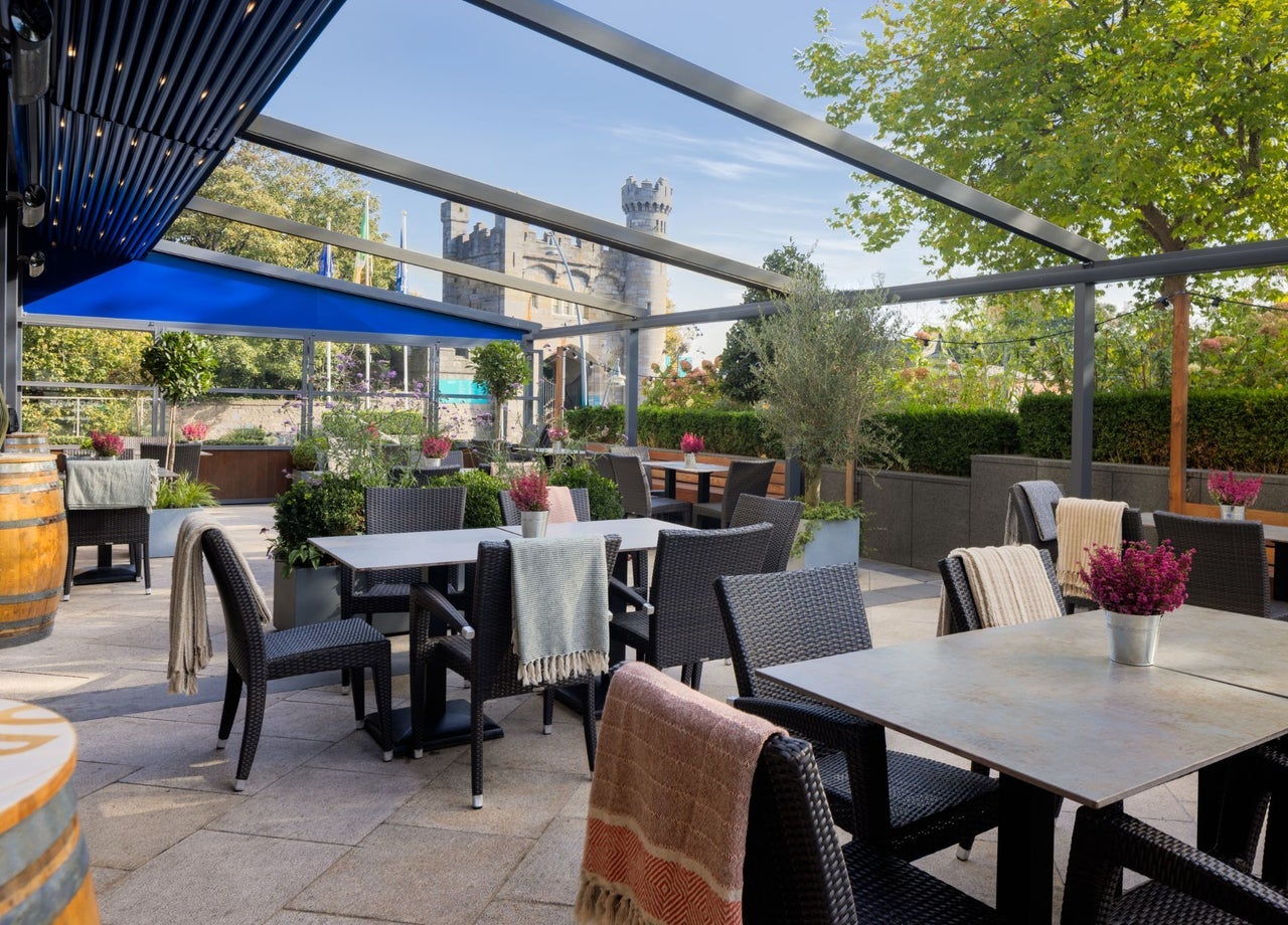 Outdoor terrace with stylish seating and castle views