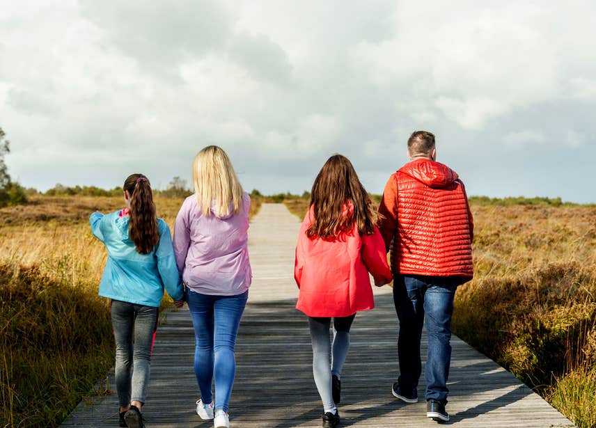 Family walking along the track way at Corlea Bog