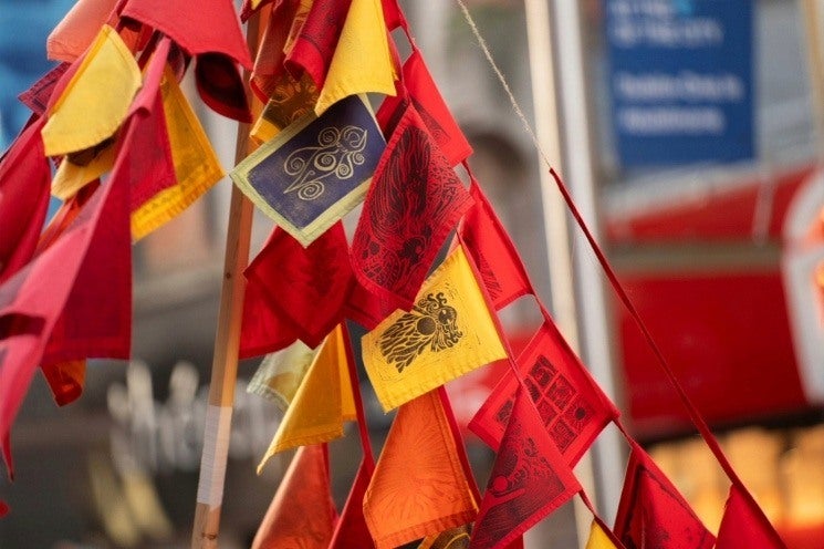 Brigid's Day Imbolg Celebration at Butler Gallery - a bunch of small flags in red, orange and yellow