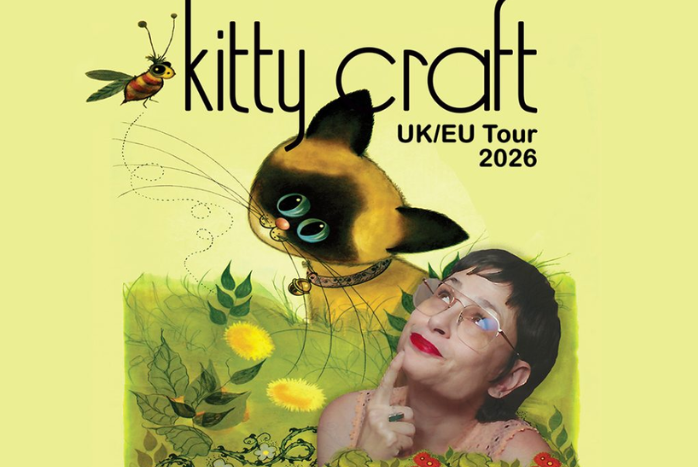 A woman smiling looking up at a cartoon image of a cat