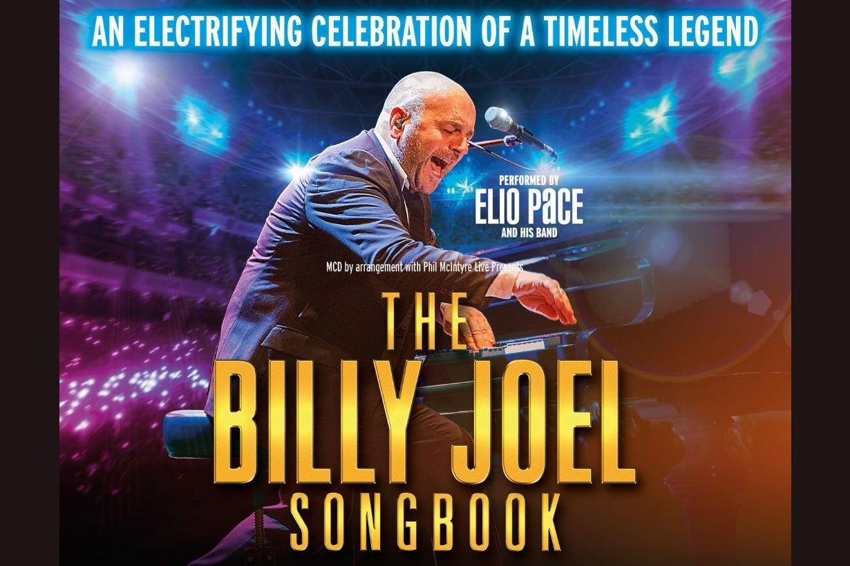 An lively man singing and playing a piano 