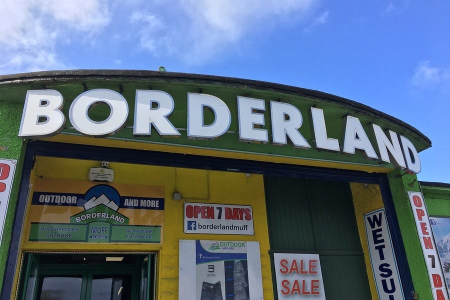 Green and yellow exterior signage and entrance to Borderland Muff