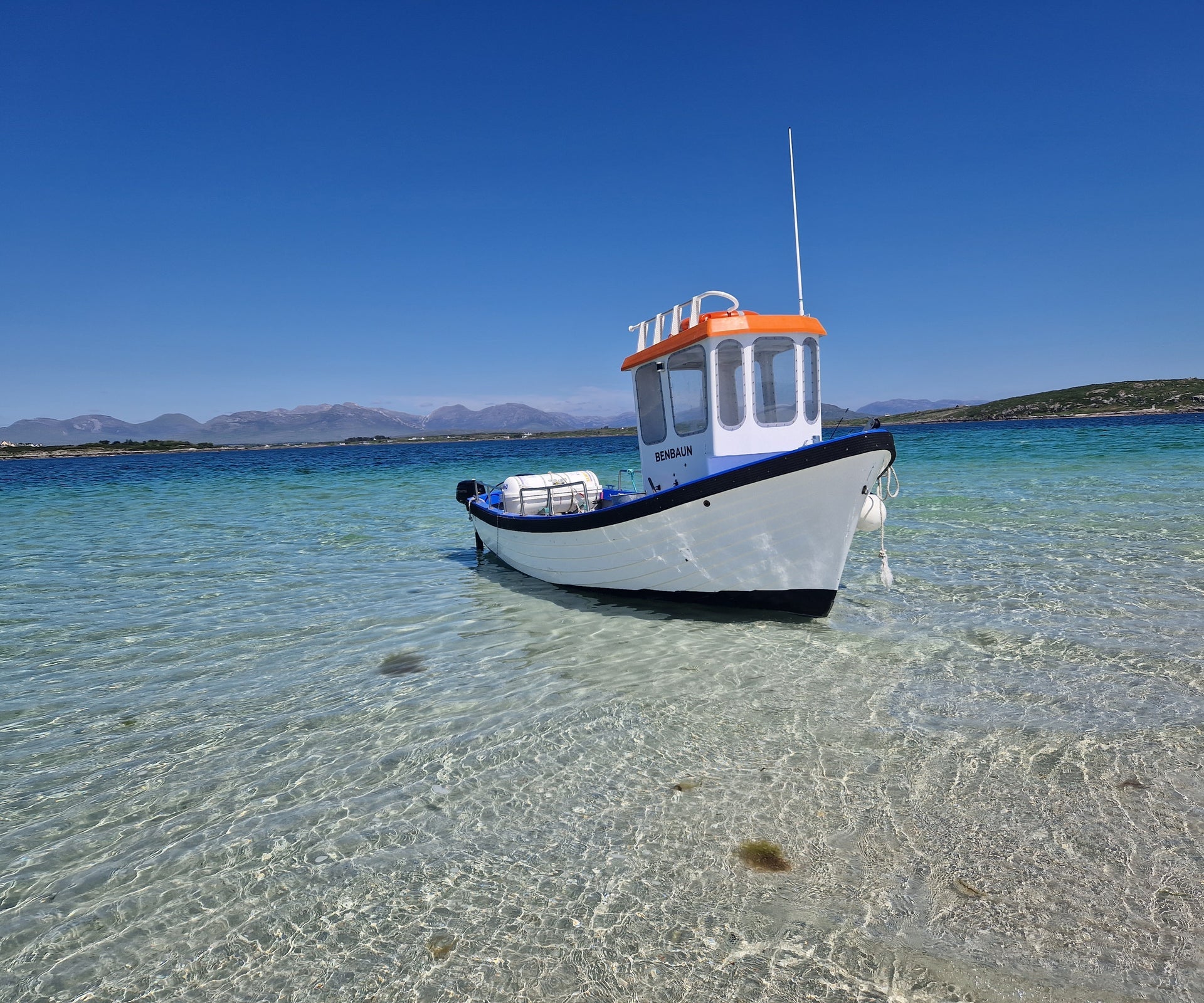 The Roundstone Bay & Island Boat Benbaun moored in the waters off Inishlacken Island