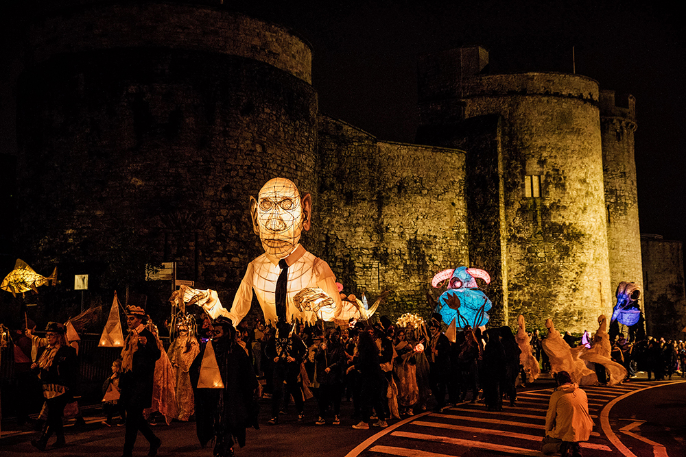Samhain Parade of Light in Limerick with King John's Castle in the background.