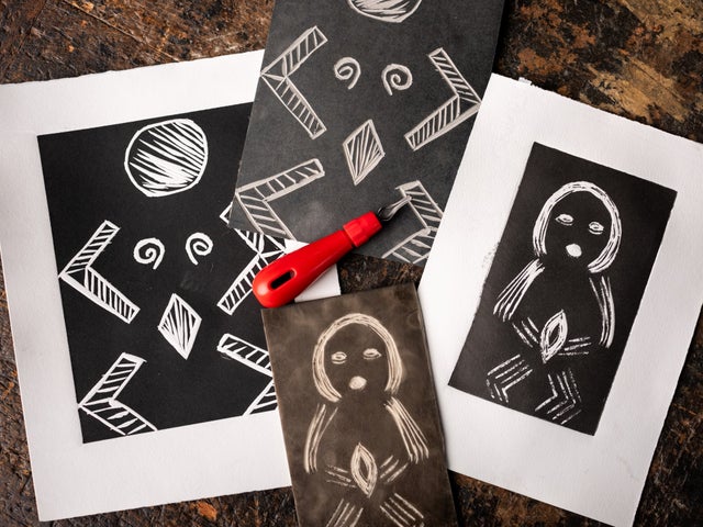 Looking down at art works in black and white on a table