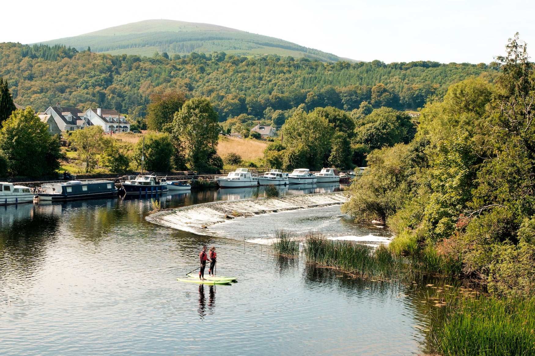 People stand-up paddleboarding in the River Barrow in Graiguenamanagh, Co Kilkenny