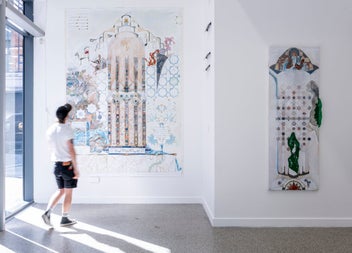 A man looking at the Shahid Diaa mixed media exhibition on display at The LAB Gallery