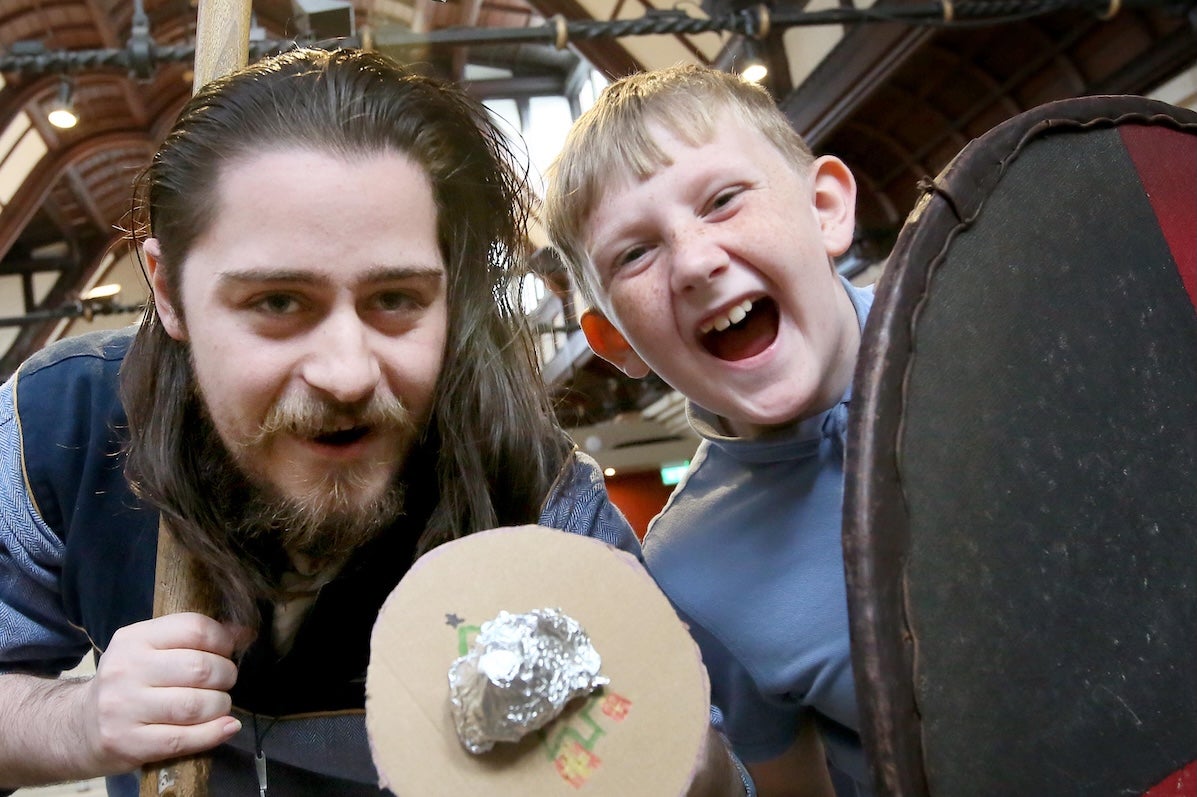 Viking and laughing boy holding shields