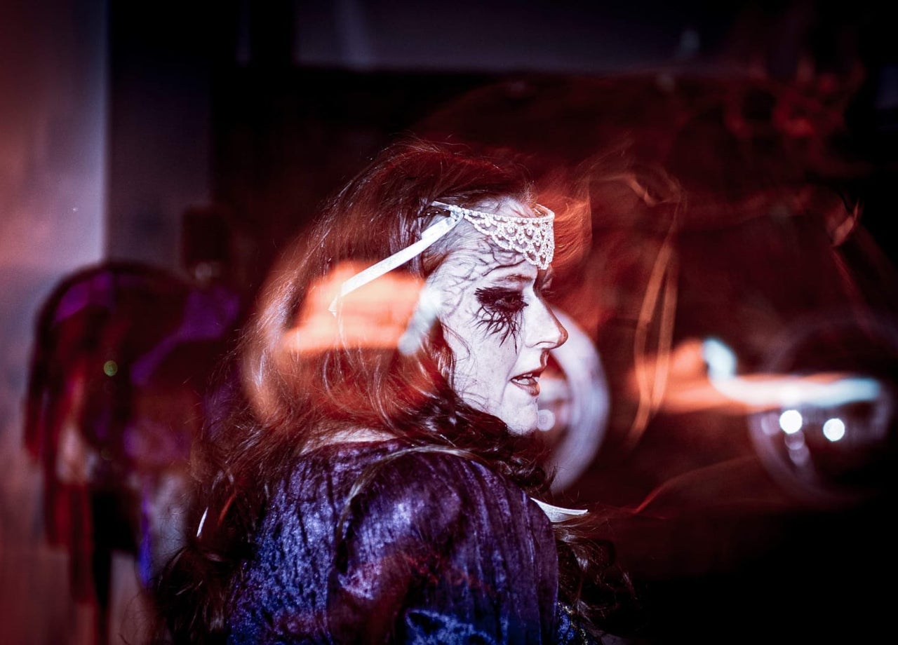 Tour guide with face decorated and dressed as a Celtic goddess