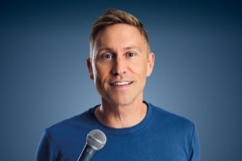 A talking man holding a mic.