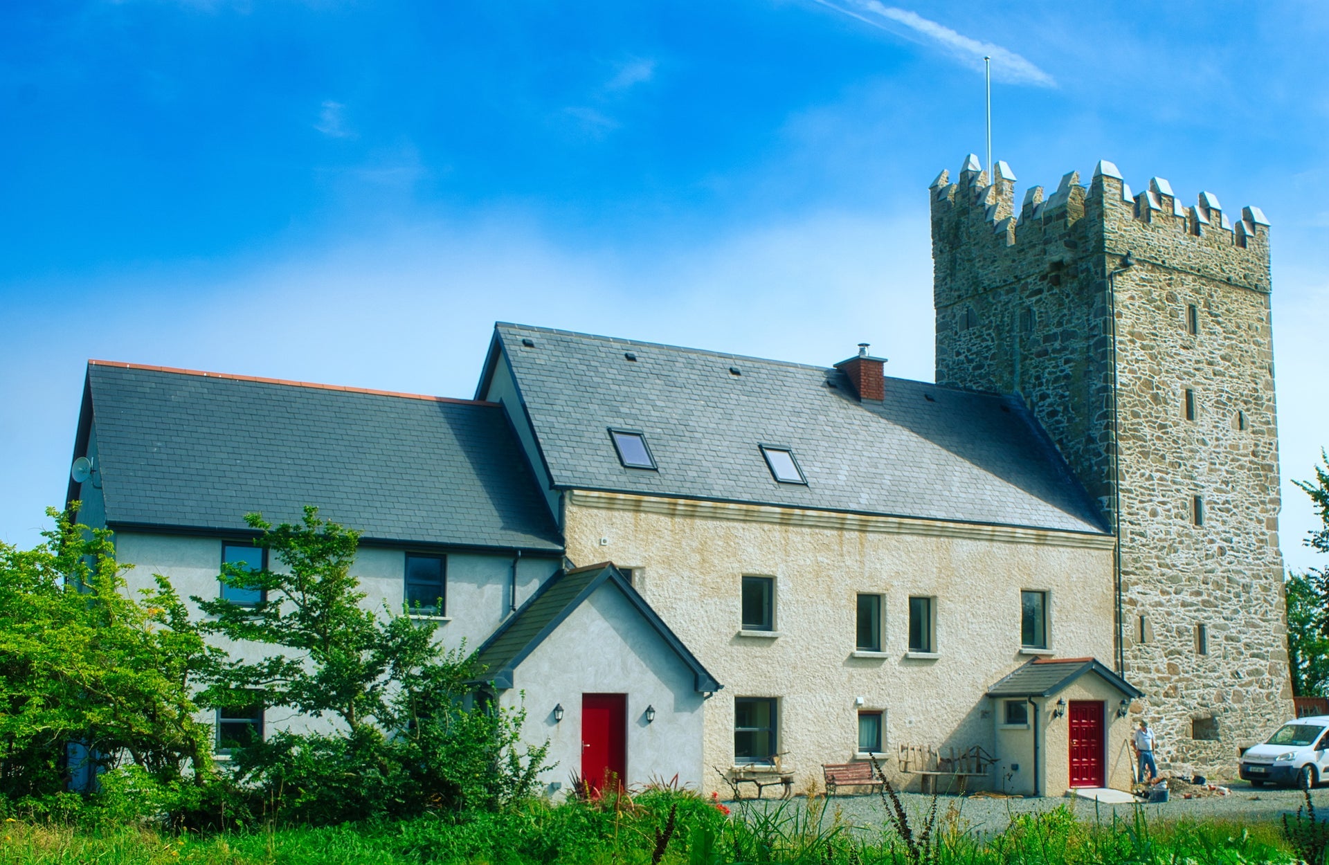 An old tower house attached to a two storey home