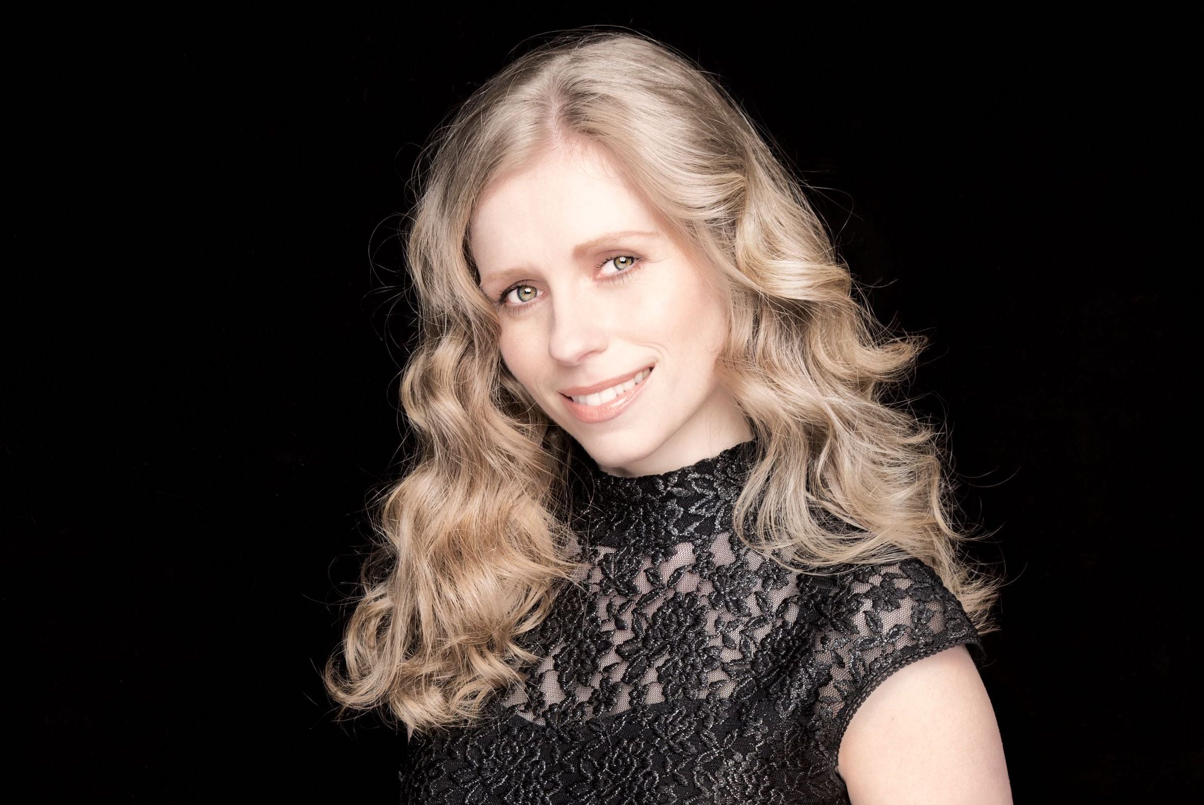 Fionnuala Moynihan is smiling in front of a black background.