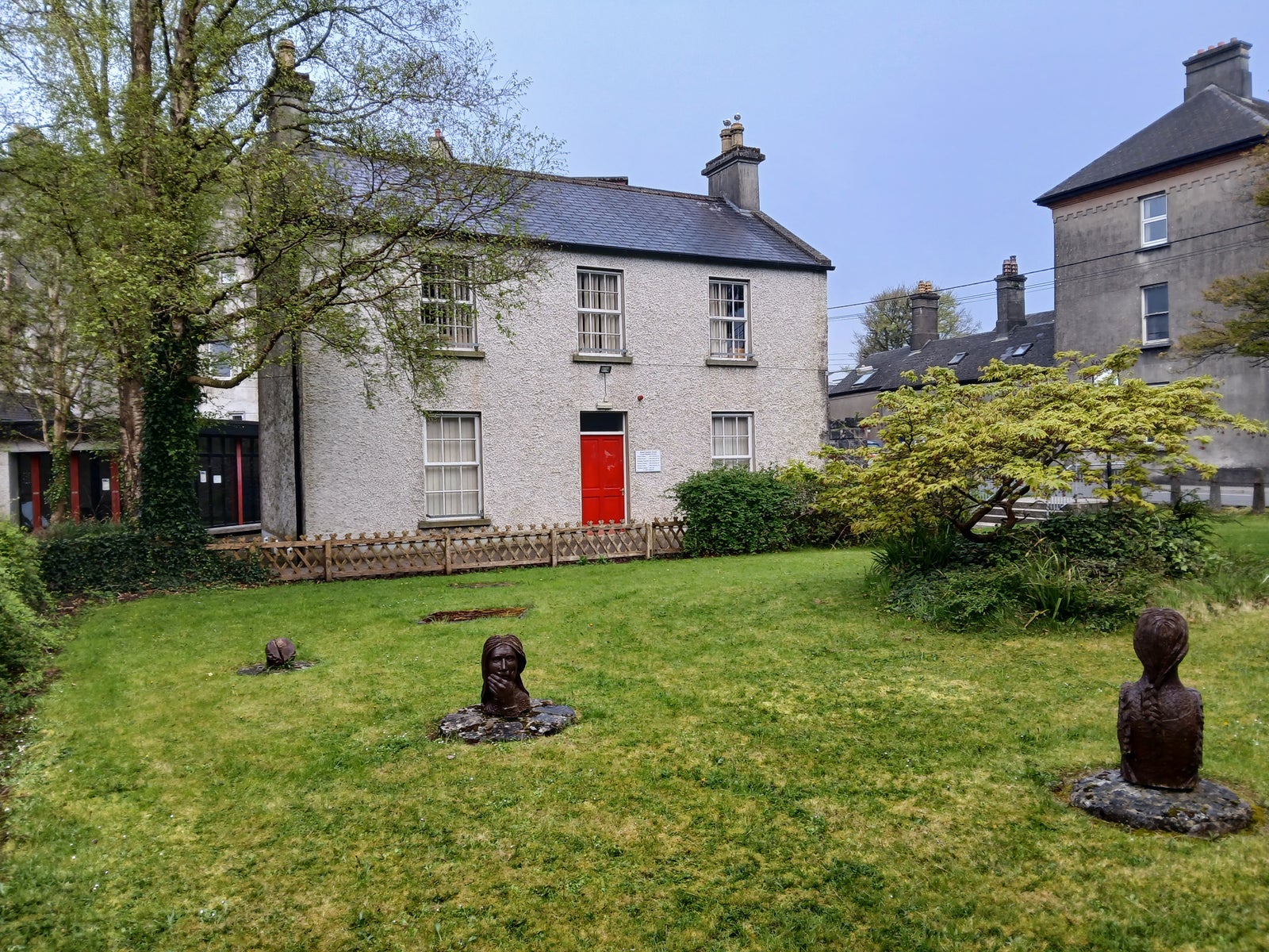 A two storey period building overlooking a small garden