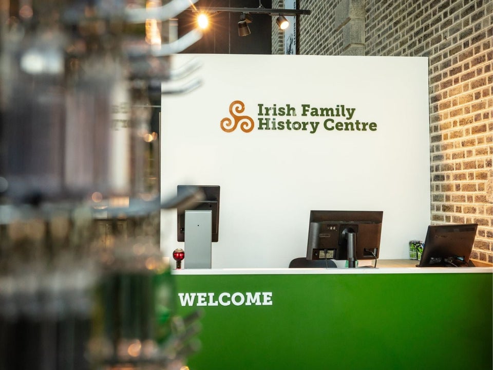Irish Family History Centre reception desk with three computer monitors