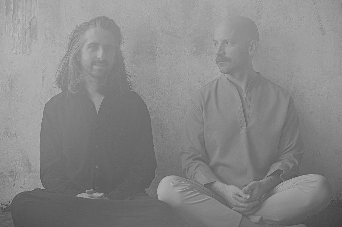 Metronome: Homebeat Present: Holden & Zimpel - grey photo of 2 men seated cross legged against a plain wall.
