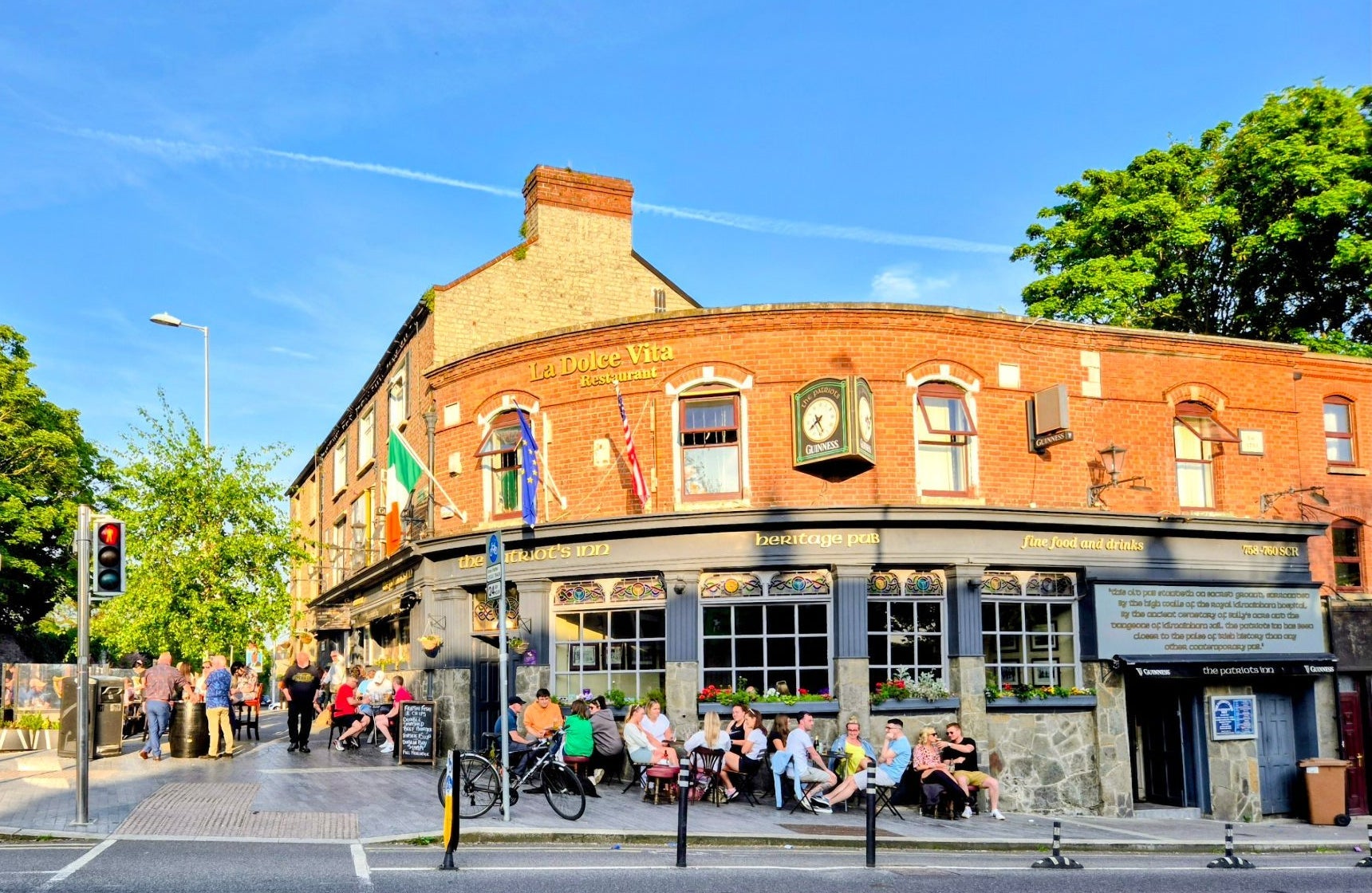 An image of the exterior of The Patriot's Inn with people sitting outside