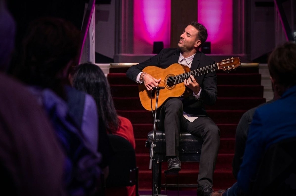 Juan José Manzano, Flamenco Guitar - a seated man playing a guitar with his eyes closed.
