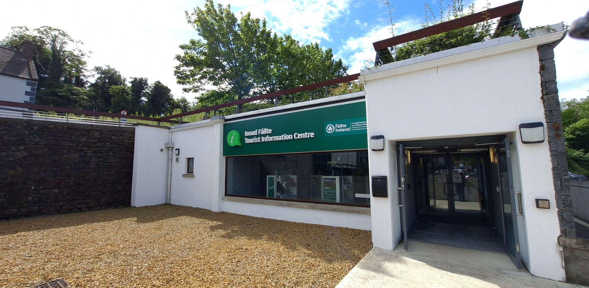 Exterior of a tourist office with official branding above the window