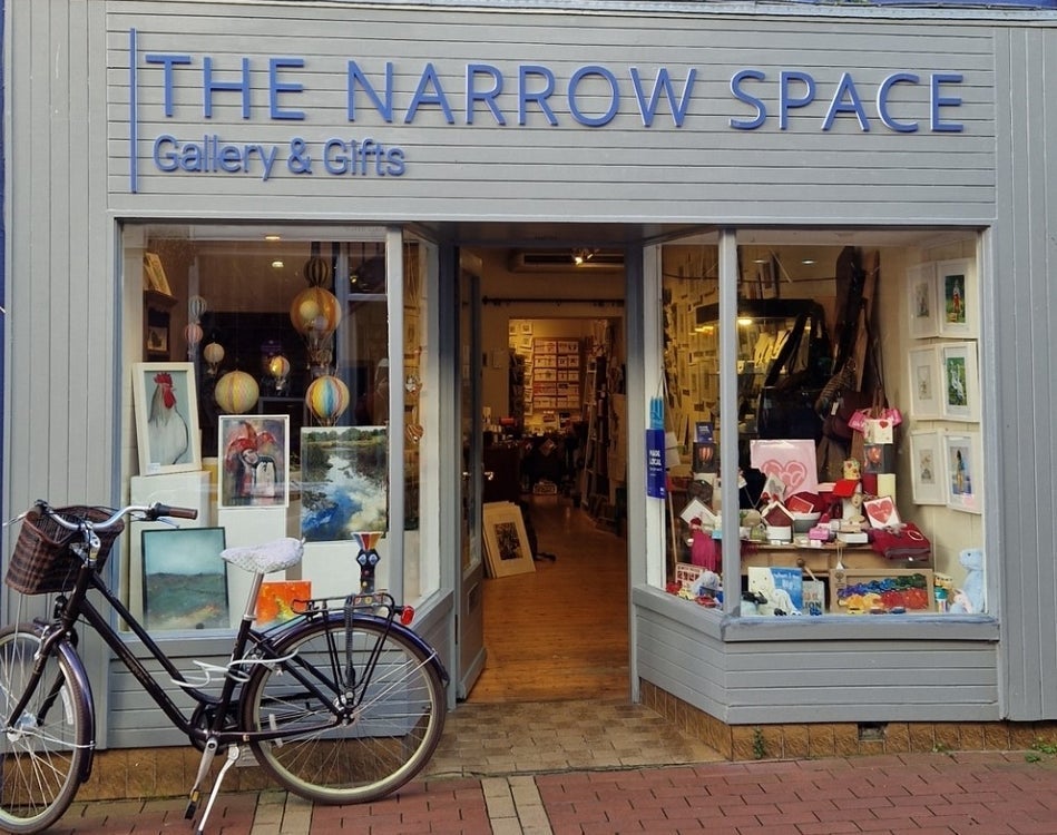 Exterior of a gallery with an eclectic mix of items on display in the windows