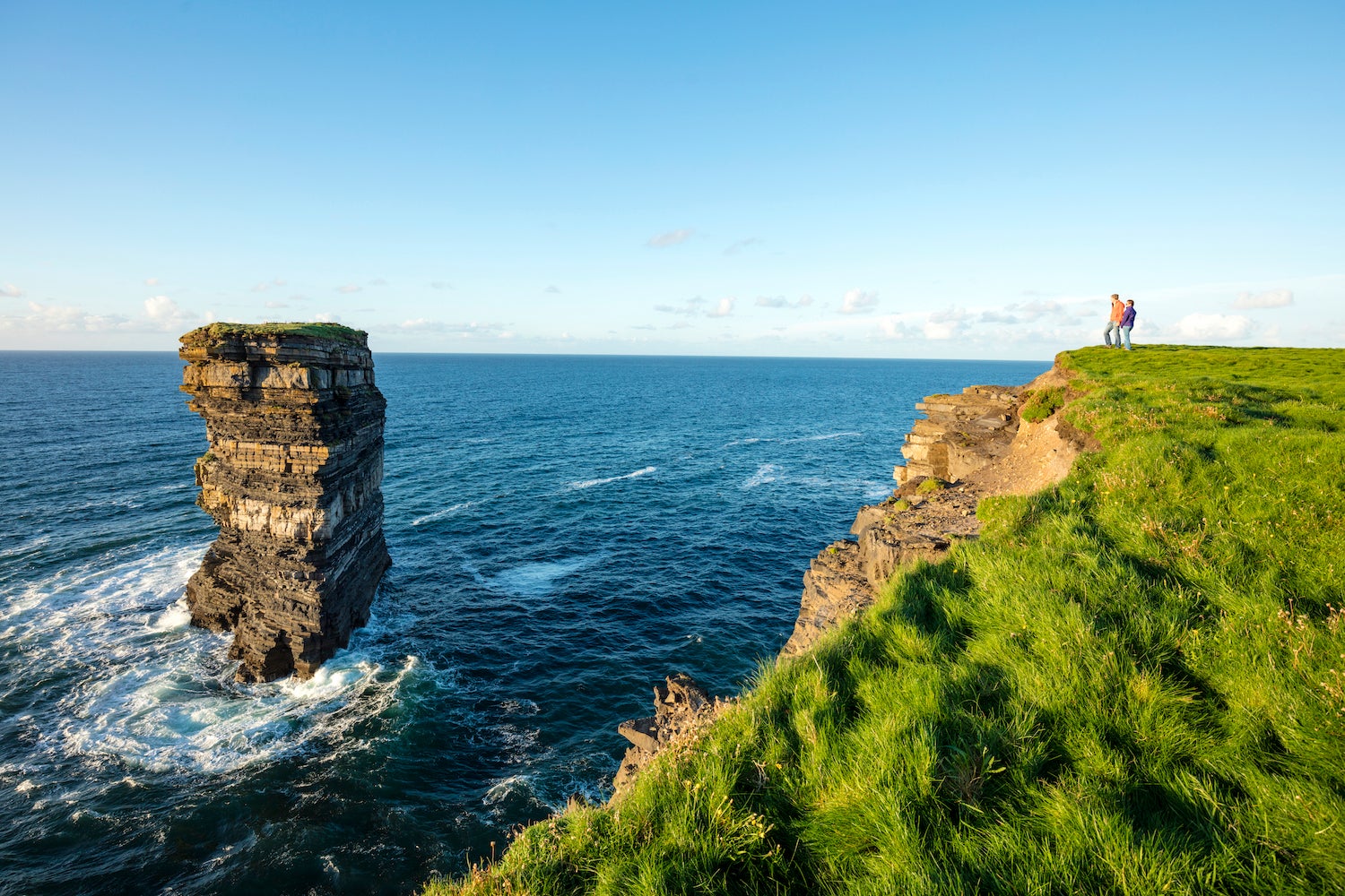 People looking out at Downpatrick Head in Mayo