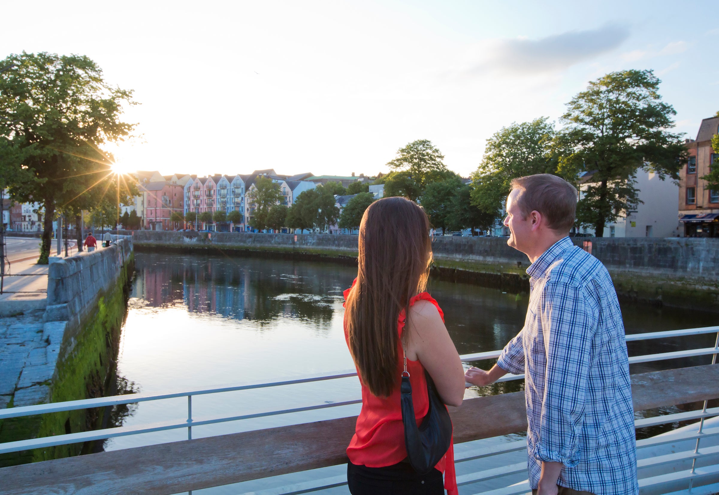 A couple looking out over the river in Cork City.