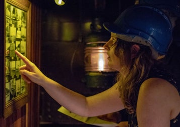 A lady looking at clues at Escape Boats