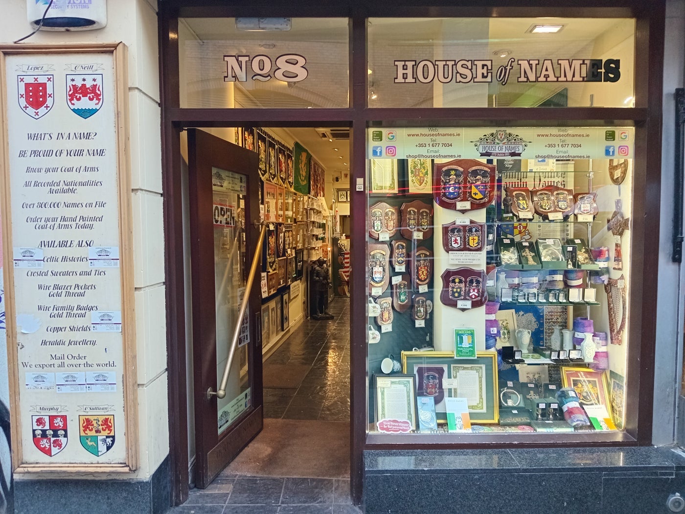 Exterior of a shop with lots of heraldic items on display at the window