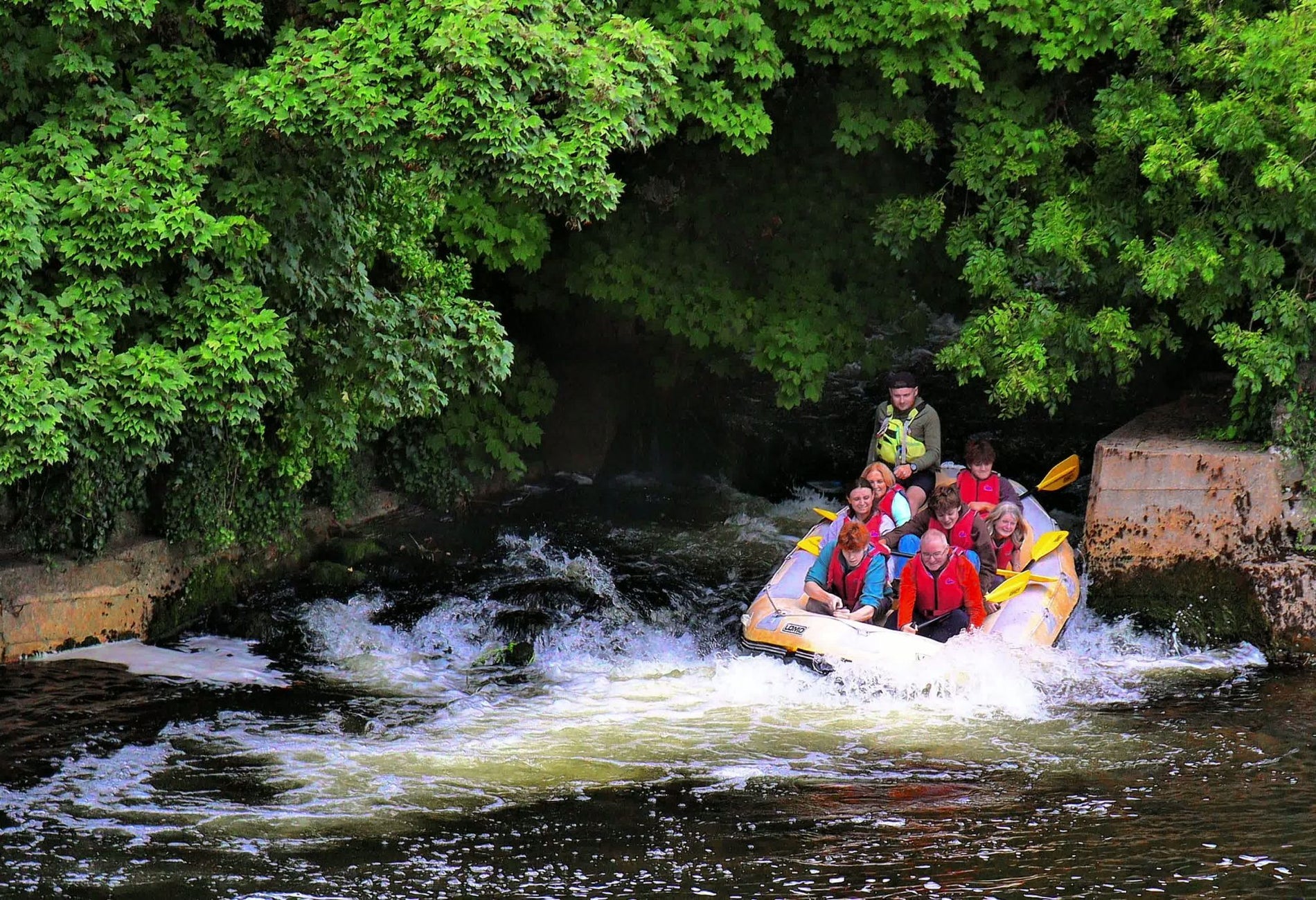 A group of people on a raft going through some rapids