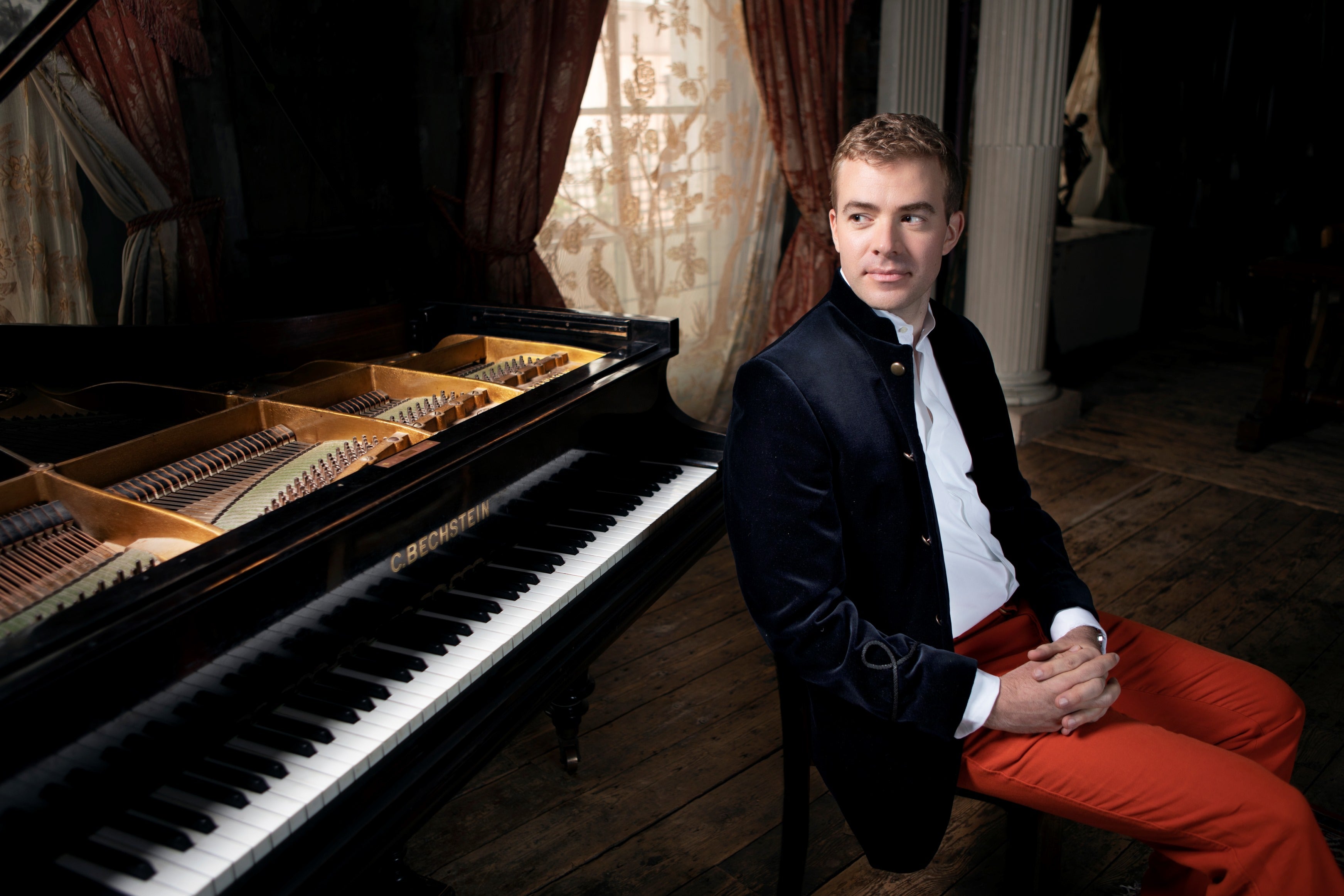 Fiachra Garvey next to a piano.