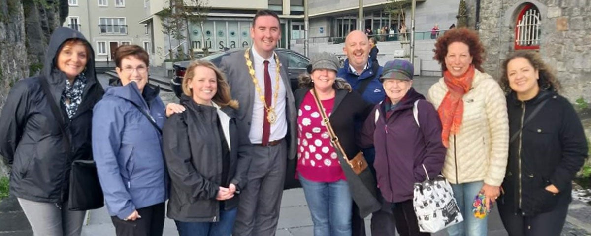 A group of ladies on tour with Tour & Taste Galway taking a photo with the Mayor of Galway