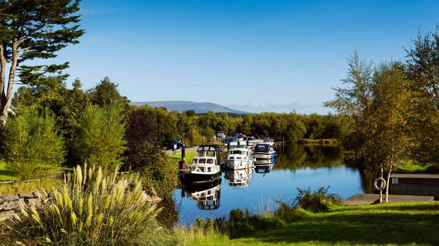 Boats on the River Shannon on a clear day with a mountain in the background