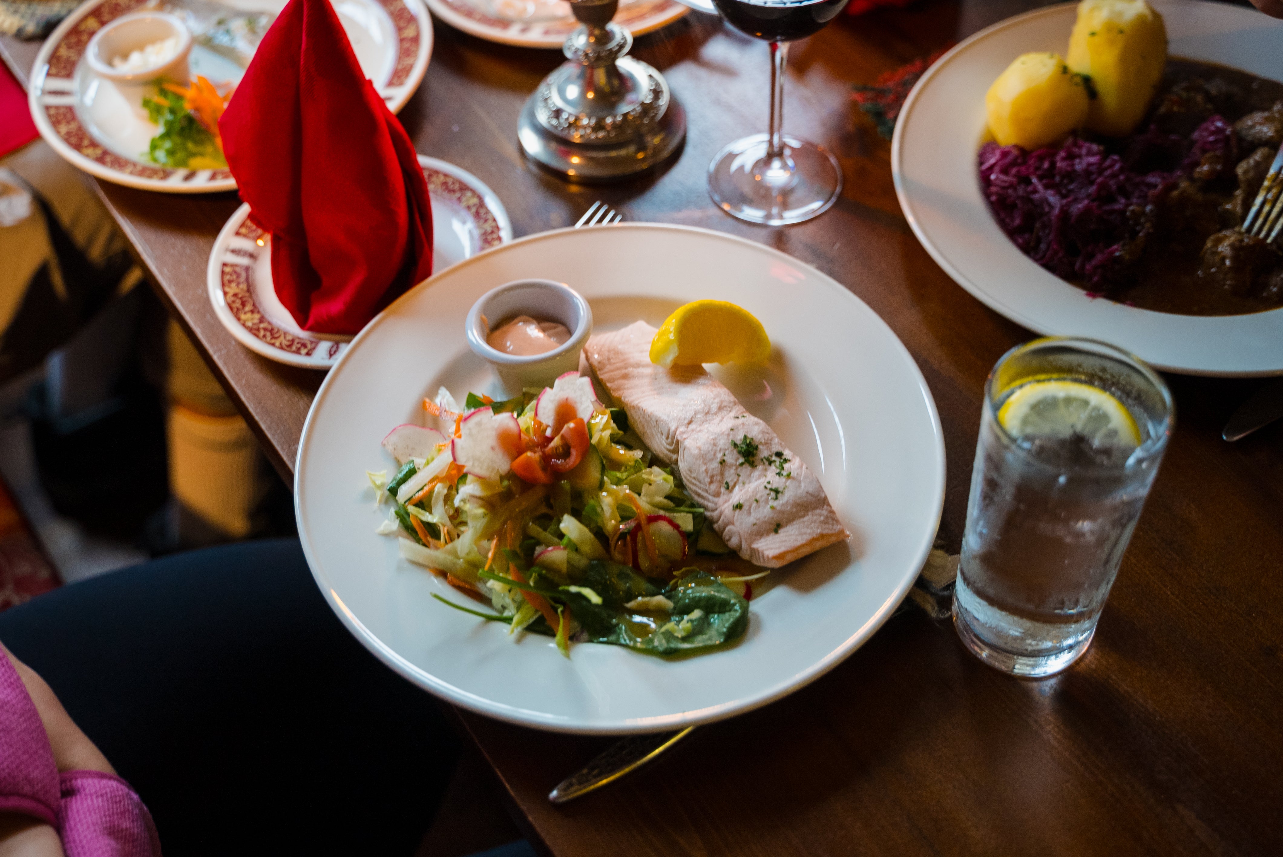 Dinner plate of fresh salmon and vegetables at a restaurant.