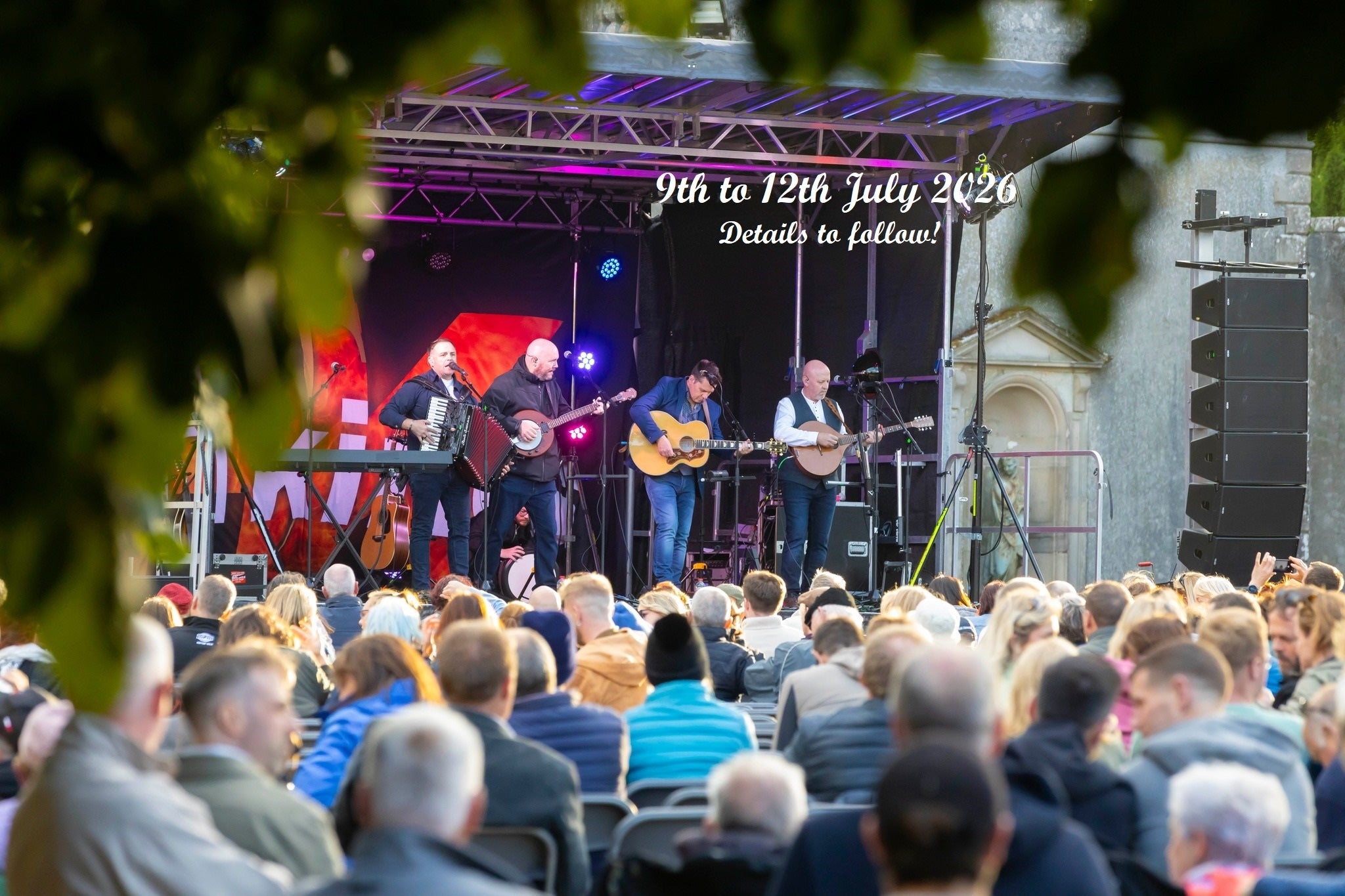 Comeraghs Wild Festival 2026 - a stage outdoors with musicians playing and audience watching on