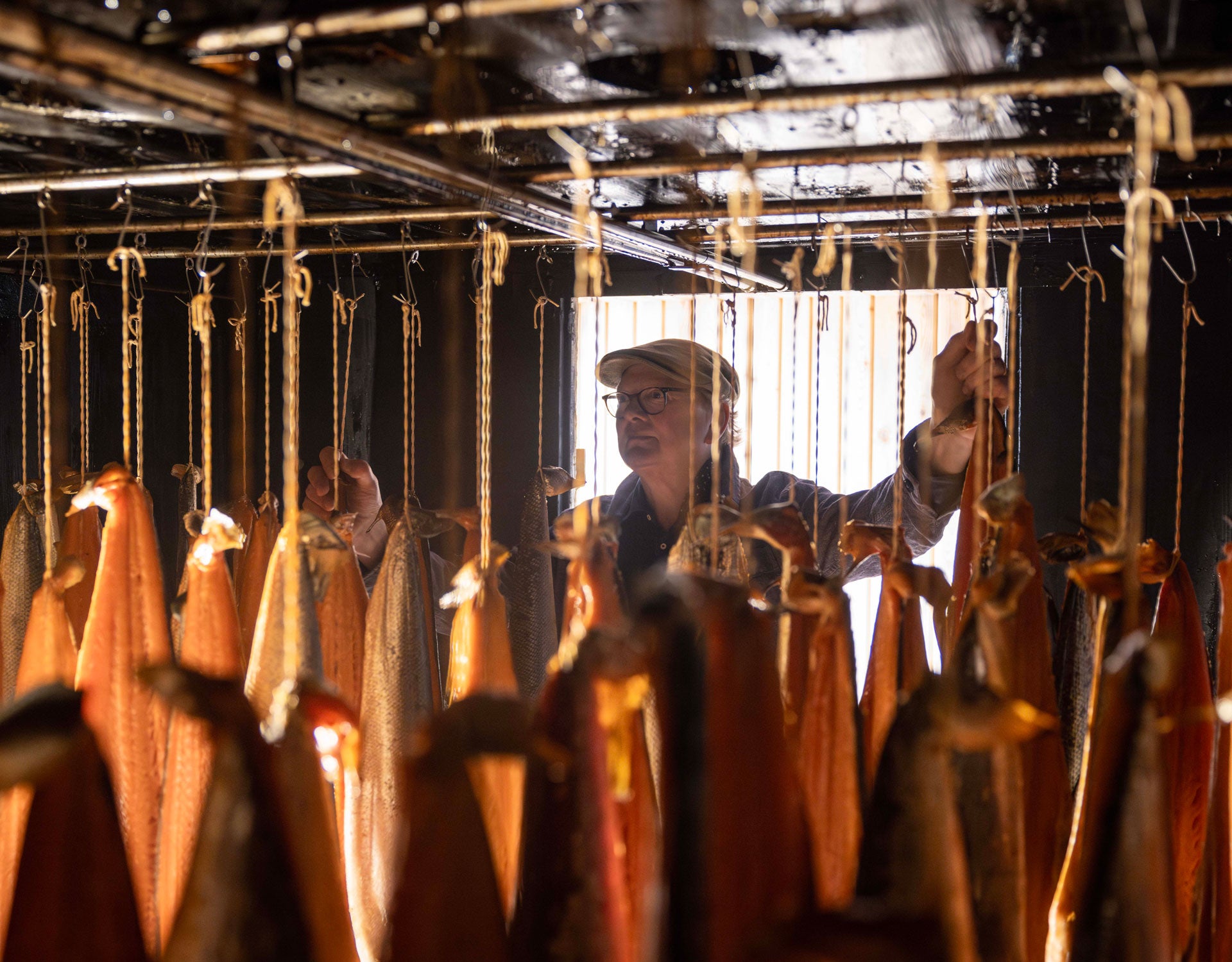 Frank Hederman working with fillets of fish hanging while been smoked