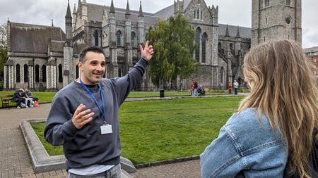 Tour guide pointing at church
