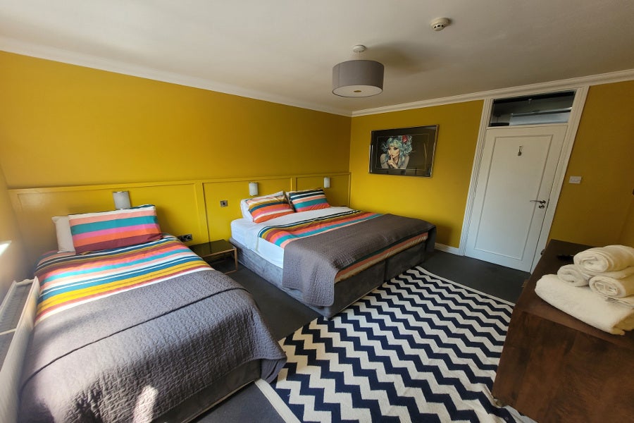 Bedroom with vibrant yellow walls