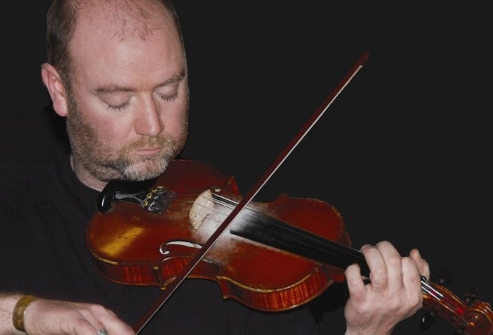 Fiddle player MacDara Ó Raghallaigh, playing a fiddle