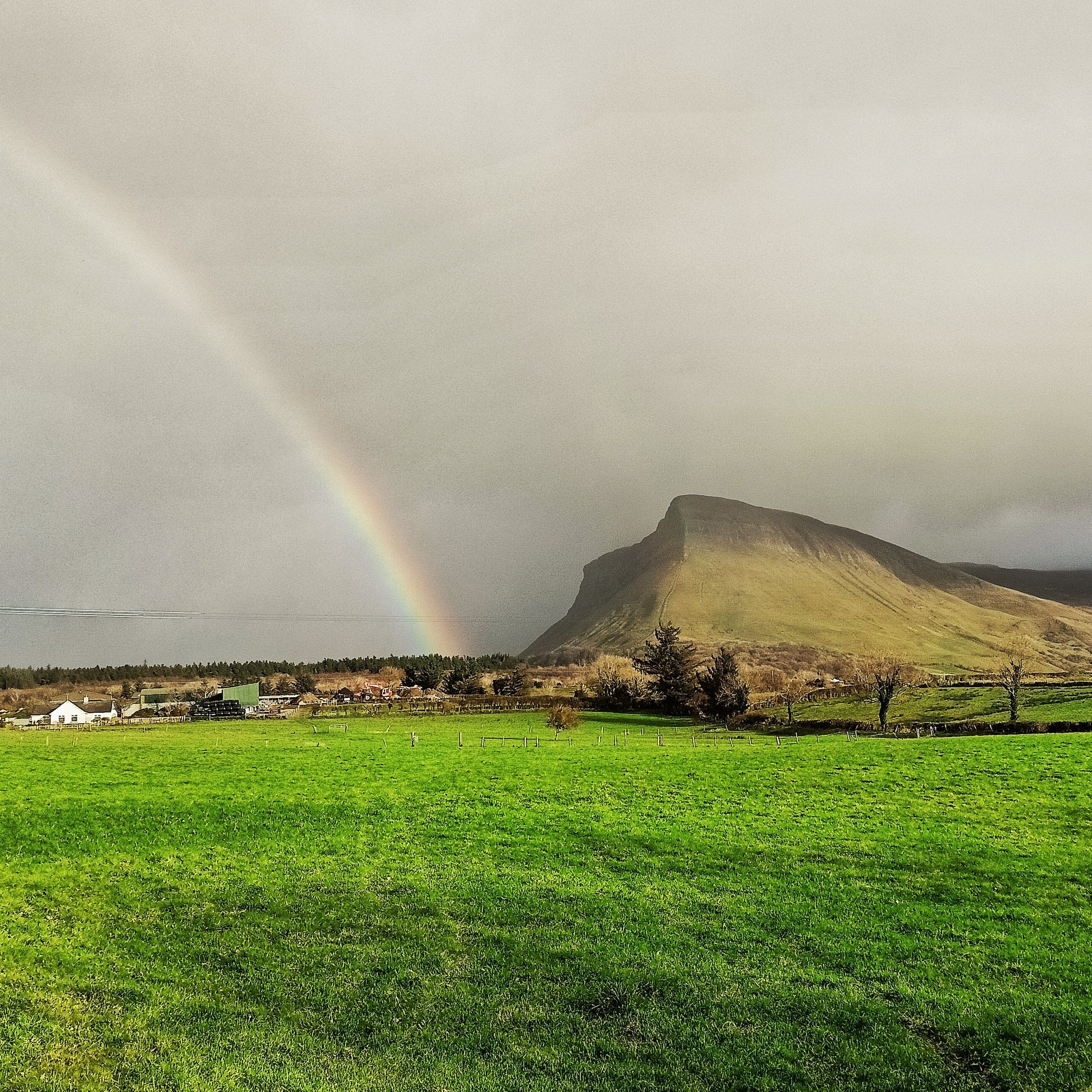 Grey sky with a rainbow near Benbulben in Sligo