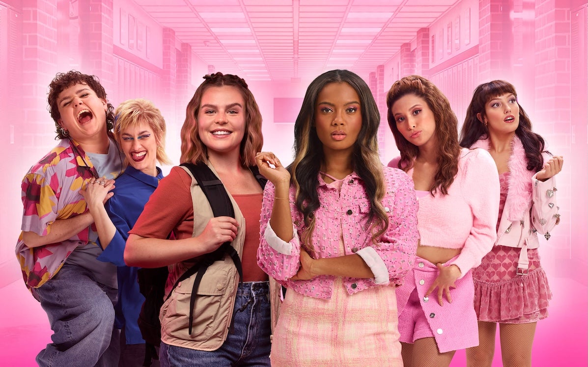 A group of young women with varying facial expressions, mostly wearing pink shades