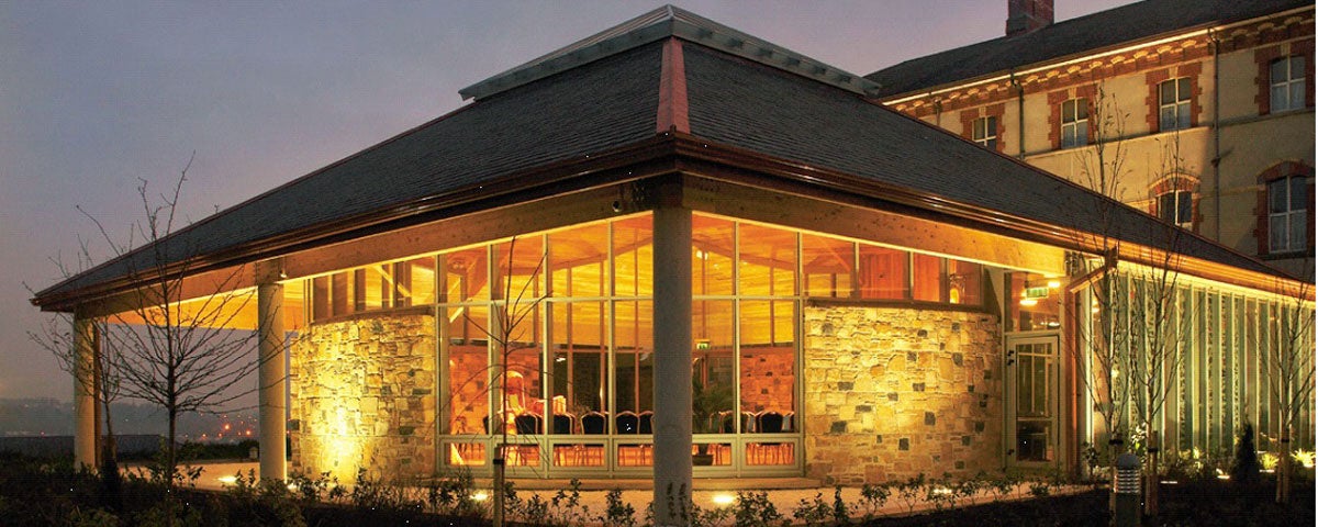 An exterior view of the Chapel by light showing the floodlit building