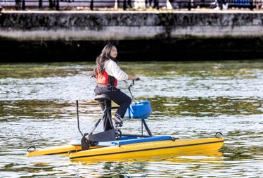 A lady using a hydrobike on the River Liffey