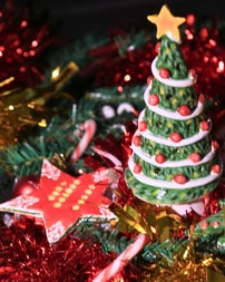 A star shaped hanging tree ornament and a 3D Christmas tree tealight holder.