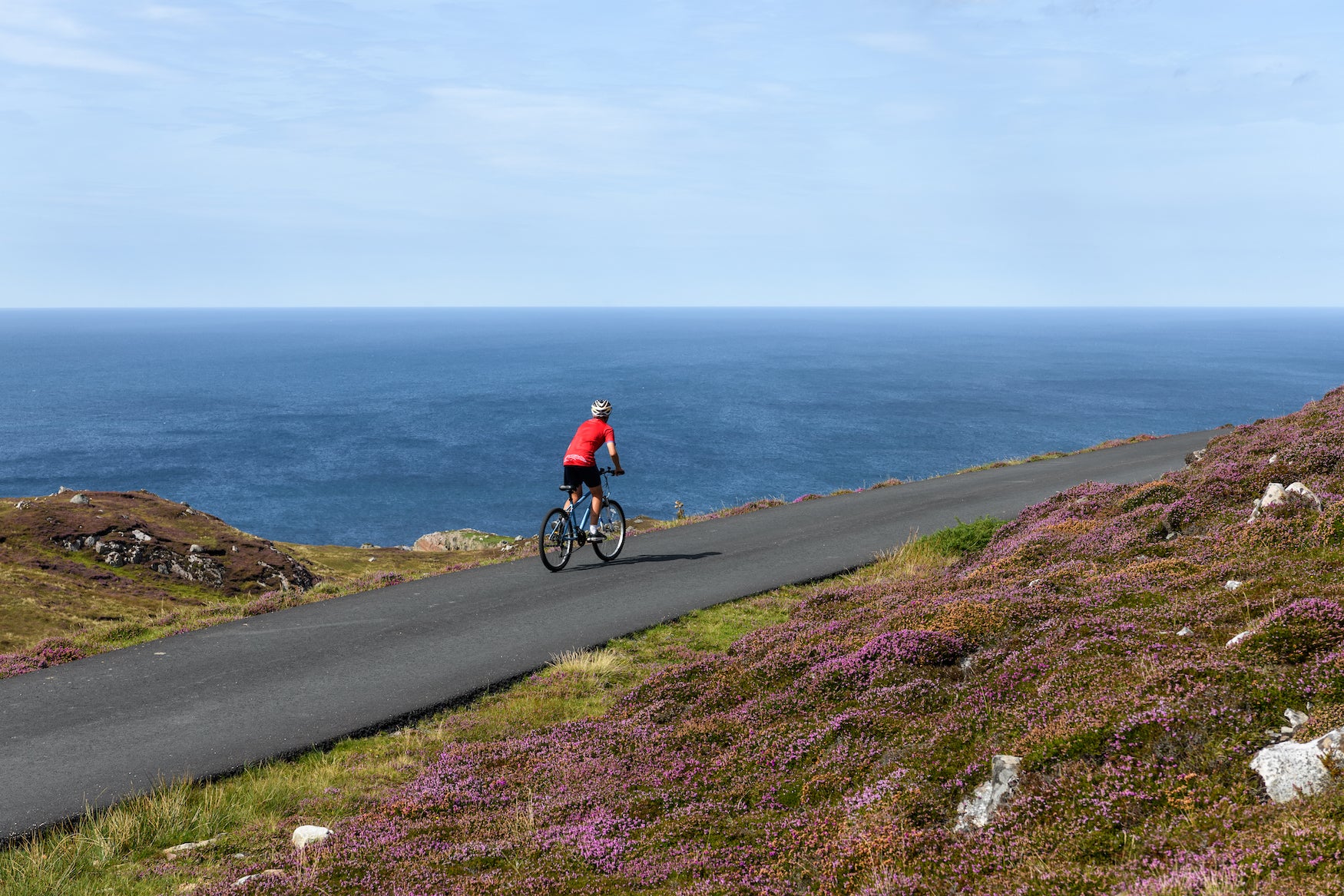 A man cycling on Arranmore Island in County Donegal