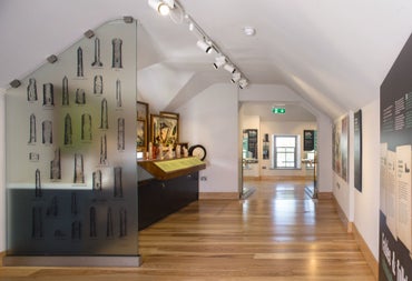 Exhibition in a room with white walls and a wooden floor
