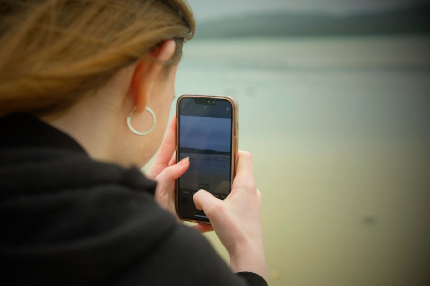 A person taking a photograph using their mobile phone