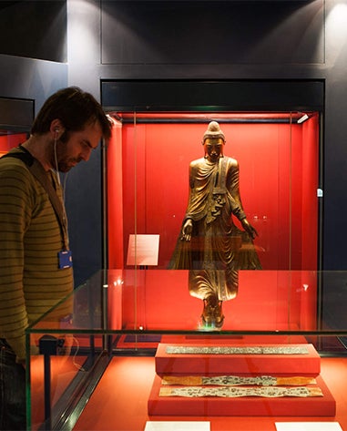 A visitor looking at a Chester Beatty exhibit