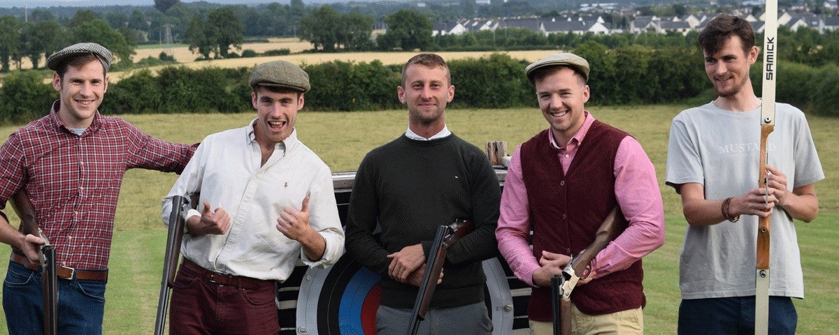 A group of people standing at an archery board at Countryside Leisure Activity Centre