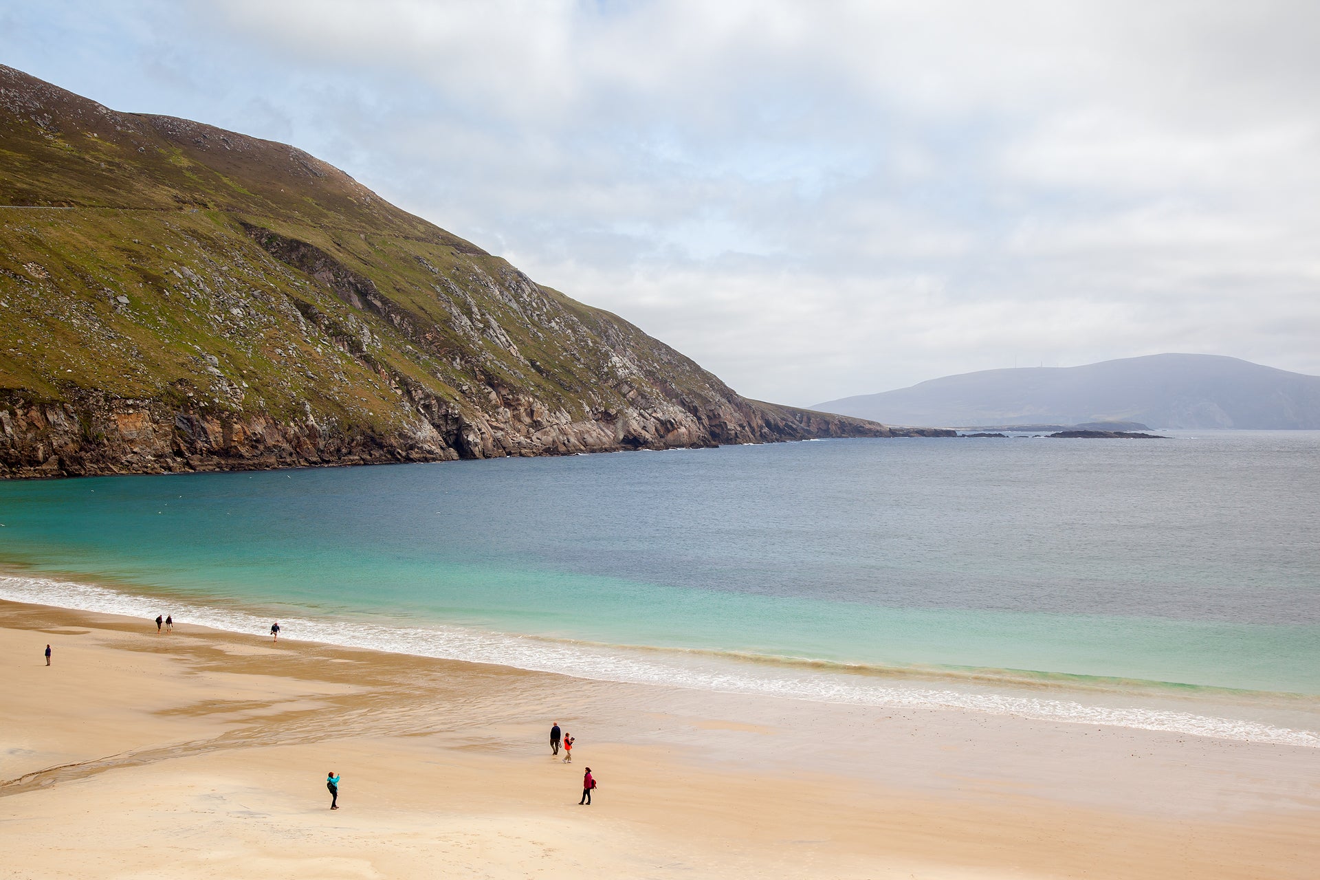 People on Keem Bay beach on Achill Island in Mayo