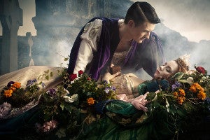 Picture of sleeping woman with man leaning towards her